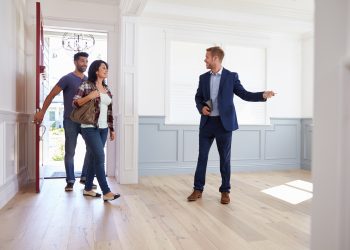 Realtor Showing Hispanic Couple Around New Home