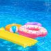 Inflatable rings, mattress and ball in blue swimming pool