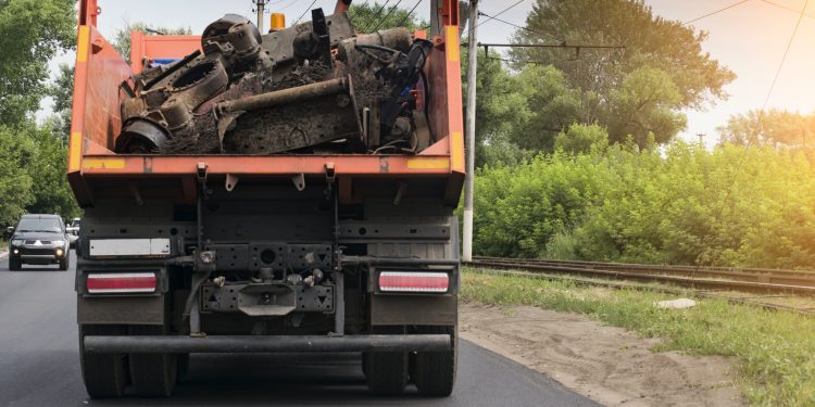 rear view of a dump truck loaded on the road laden with scrap metal