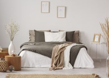 Spacious bedroom interior in beige and olive colour