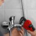 Plumber repairing faucet in shower, closeup