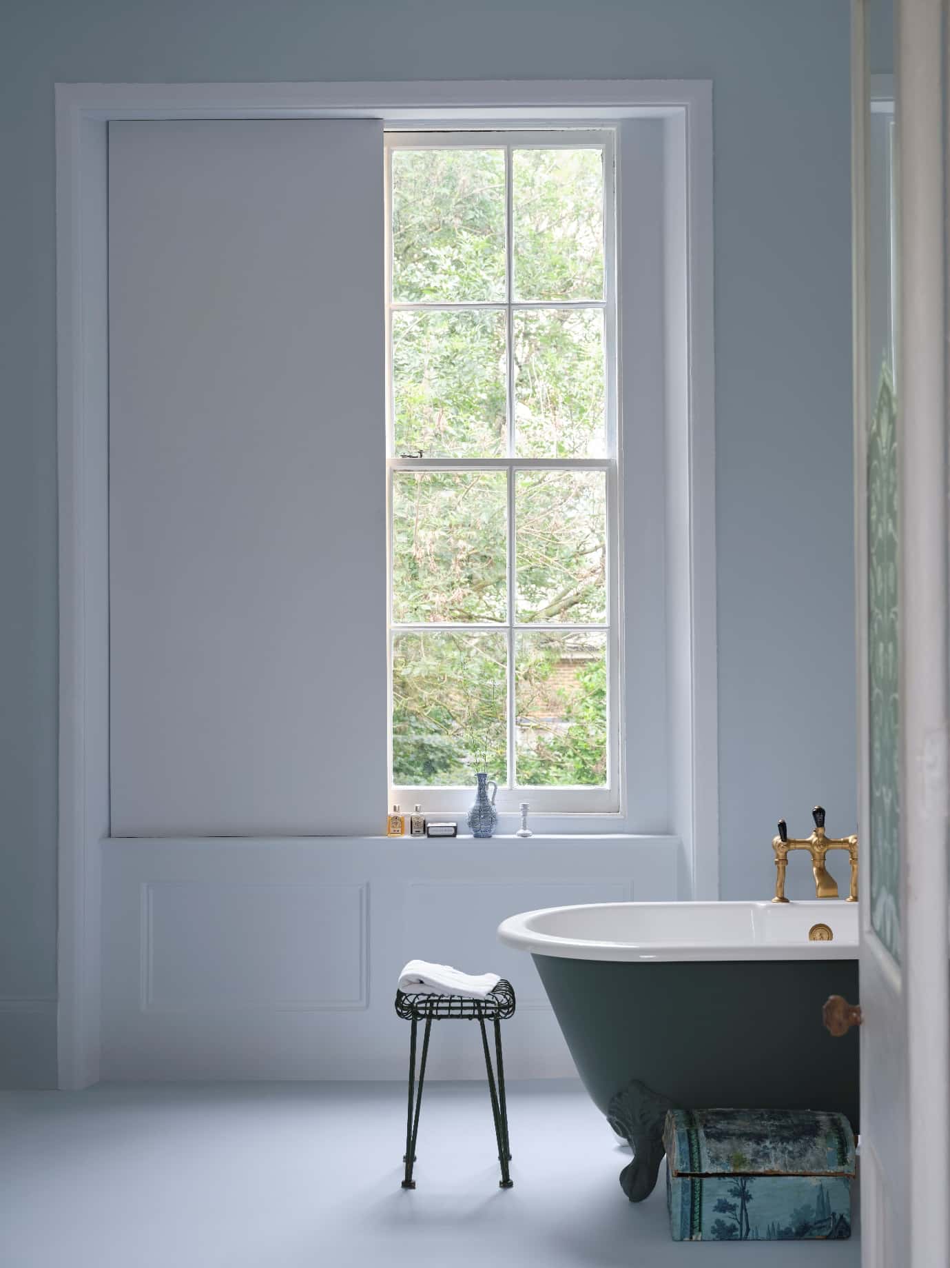 A bathroom with a tub and a window