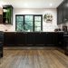 A kitchen with black cabinets Description automatically generated with medium confidence