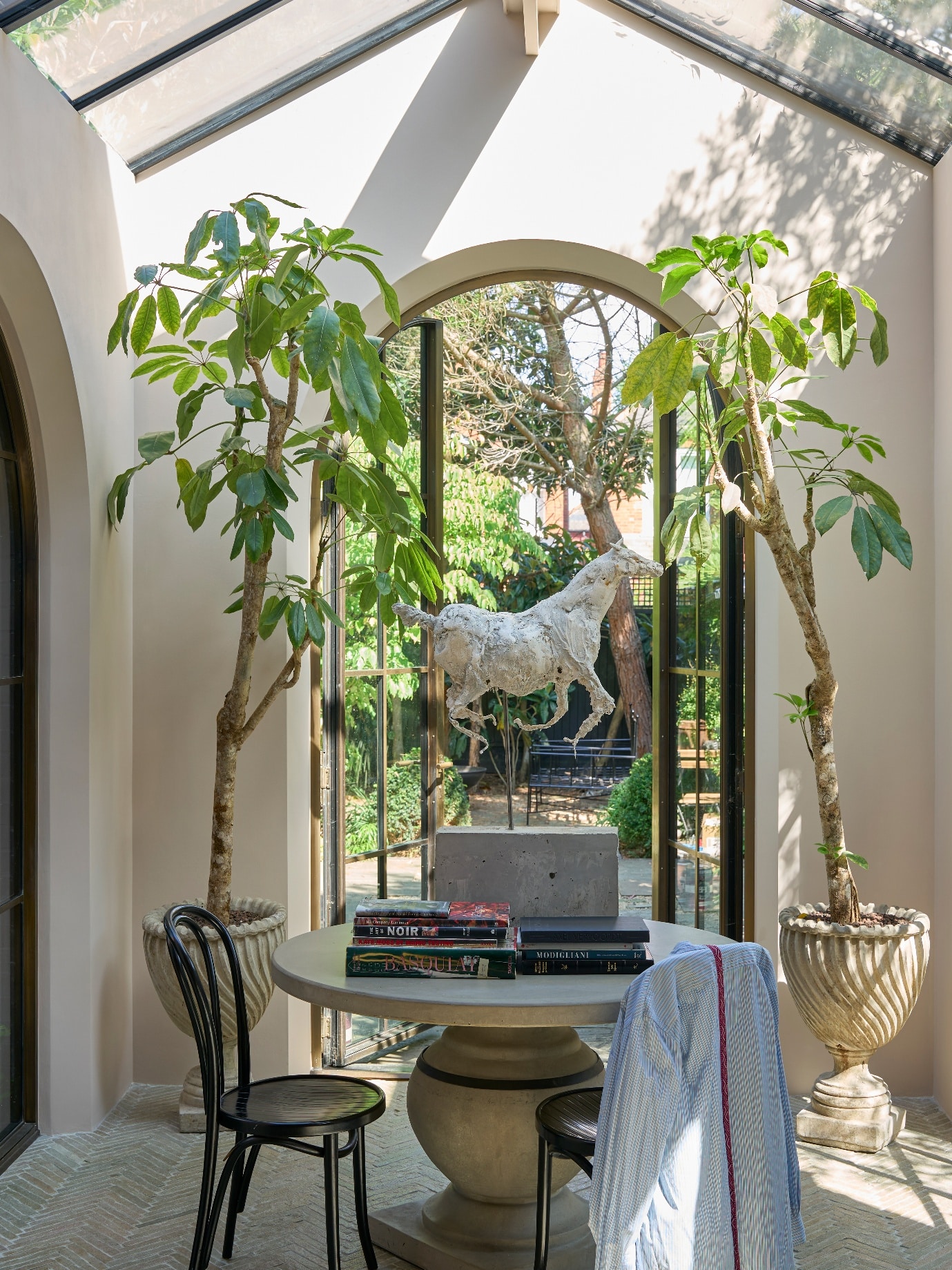 A room with a table and two trees