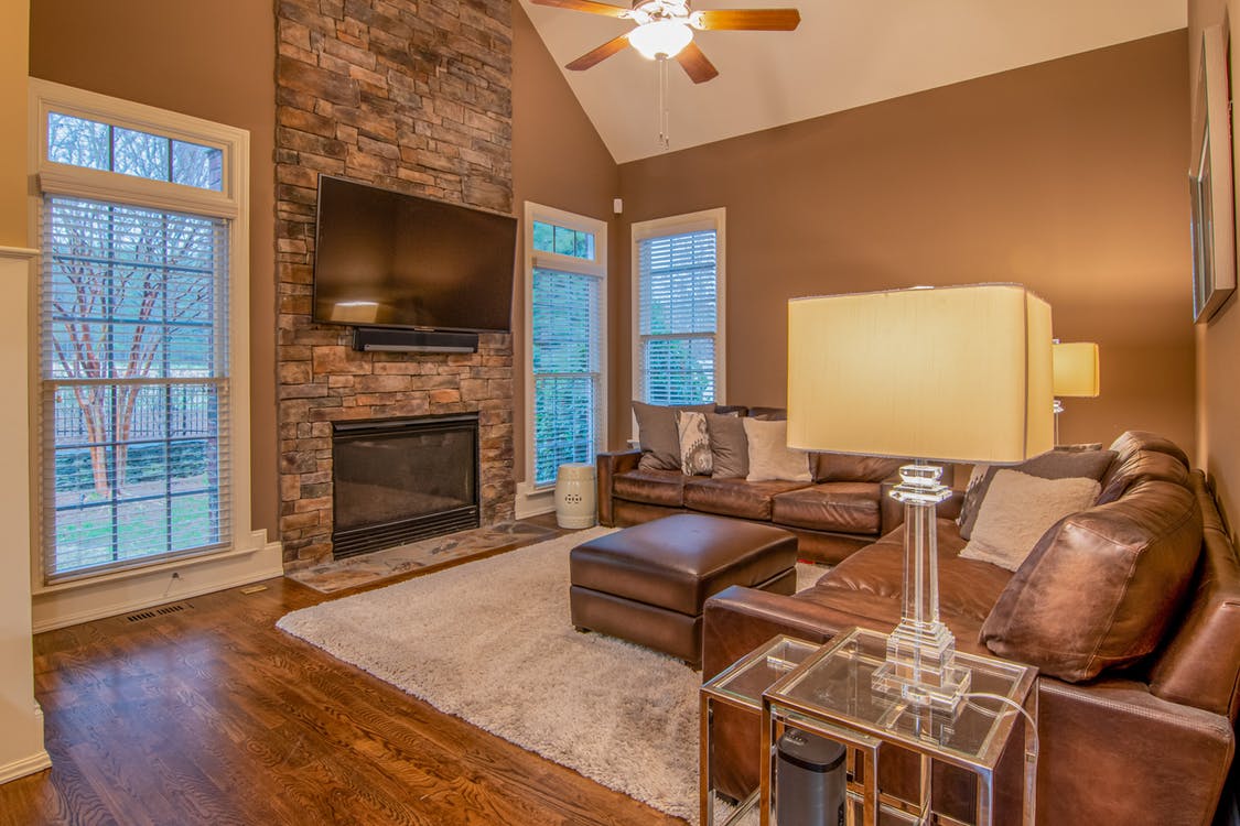 Brown Leather Couch Beside Brown Wooden Table