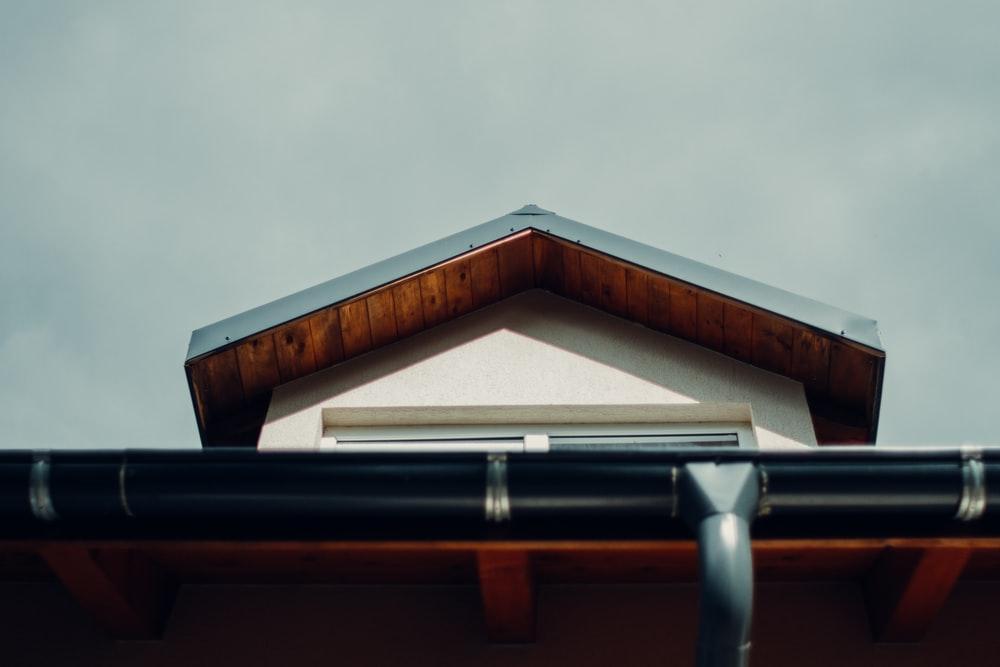 brown wooden roof under white sky during daytime