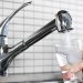 Filling glass of water from stainless steel kitchen faucet