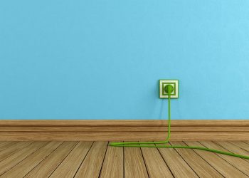 Energy efficiency concept with green electric plugs on blue wall - rendering -
