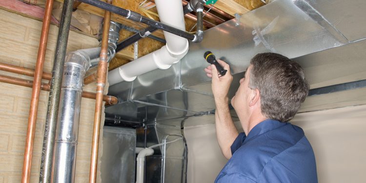 Handyman inspecting pipes